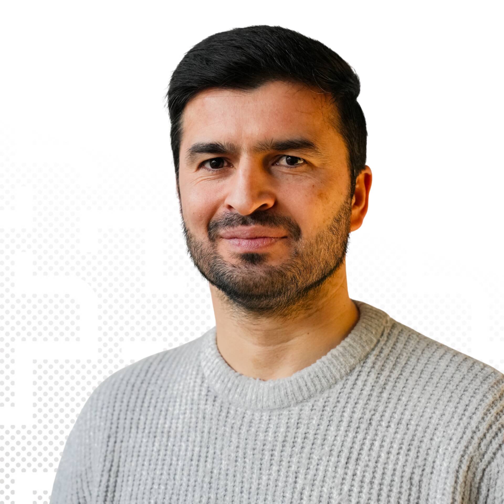 A professional business portrait of Hassibullah Baghlani with black hair against a white background.